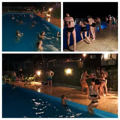 a group of people in a swimming pool at night at grote lodge safaritent 4 in Camurac