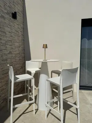 a white table and chairs in a room at Villa moderne avec Piscine et cuisine extérieure in Saint-Nazaire-dʼAude