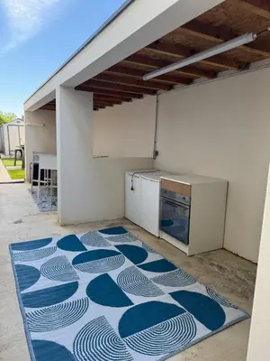 a kitchen with a blue and white rug on the floor at Villa moderne avec Piscine et cuisine extérieure in Saint-Nazaire-dʼAude