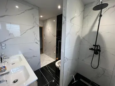 a bathroom with a shower and a sink and a toilet at Villa moderne avec Piscine et cuisine extérieure in Saint-Nazaire-dʼAude