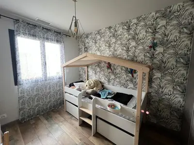 a childs bedroom with a bed with a canopy at Villa moderne avec Piscine et cuisine extérieure in Saint-Nazaire-dʼAude