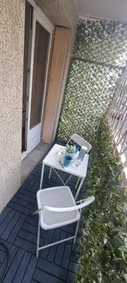 a white table and a chair on a patio at Charmant studio à Castres in Castres