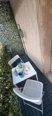 a white table and two chairs on a patio at Charmant studio à Castres in Castres