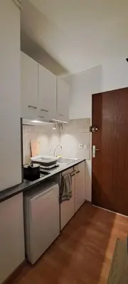 a kitchen with white cabinets and a counter top at Charmant studio à Castres in Castres