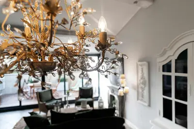 a chandelier in a dining room with a table and chairs at Le Tranquille characterful apartment in Carcassonne