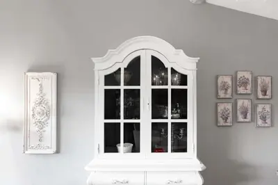 a white window in a white wall with pictures at Le Tranquille characterful apartment in Carcassonne