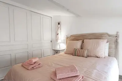 a bedroom with a bed with pink towels on it at Le Tranquille characterful apartment in Carcassonne