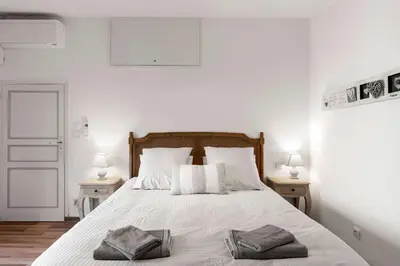 a bedroom with a bed with two towels on it at Le Tranquille characterful apartment in Carcassonne