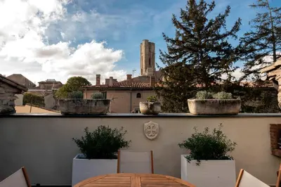 a patio with a table and chairs on a balcony at Le Tranquille characterful apartment in Carcassonne