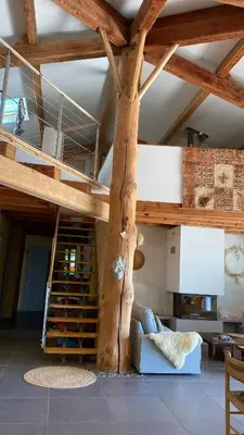 a living room with a room with a wooden ceiling at Chambre confortable à la campagne in Dun