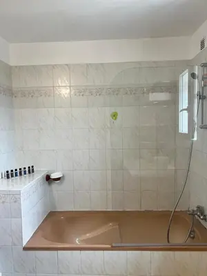 a bath tub in a bathroom with a shower at Villa piscine privée in Capestang