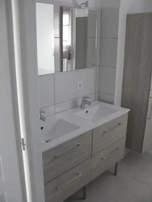 a white bathroom with a sink and a mirror at Douce Parenthèse - Maison de Vacances - 8 pers - Terrasse in Lapalme