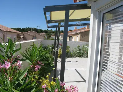 a glass door with a view of a garden at Douce Parenthèse - Maison de Vacances - 8 pers - Terrasse in Lapalme