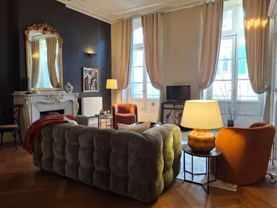 a living room with a couch and a mirror at The Grand 42 - stylish apartment in Carcassonne