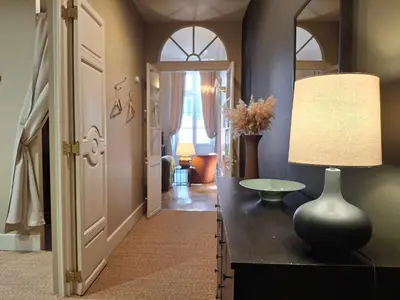 a hallway with a table with a lamp on it at The Grand 42 - stylish apartment in Carcassonne