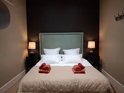 a bedroom with two towels on a bed at The Grand 42 - stylish apartment in Carcassonne