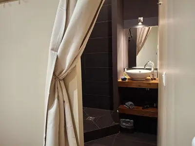 a bathroom with a sink and a mirror at The Grand 42 - stylish apartment in Carcassonne