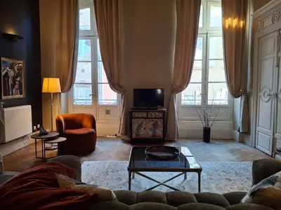 a living room with a couch and a tv at The Grand 42 - stylish apartment in Carcassonne