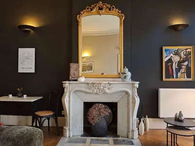 a living room with a fireplace and a mirror at The Grand 42 - stylish apartment in Carcassonne