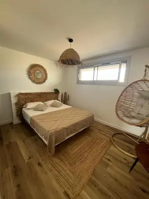 a bedroom with a bed and a window at APPARTEMENT Rénové de type 3 VUE MER in Port-la-Nouvelle