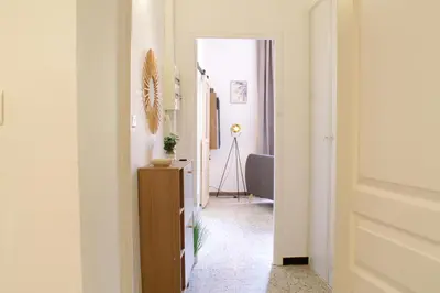 a hallway with a door leading to a room at Chez Céline, plein centre ville in Narbonne