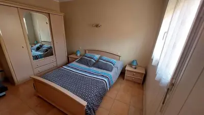 a small bedroom with a bed and a mirror at Charmant T2 à 5min des plages in Port-la-Nouvelle
