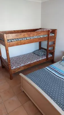 a pair of wooden bunk beds in a room at Charmant T2 à 5min des plages in Port-la-Nouvelle