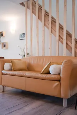 a brown leather couch in a living room at Hygge en Méditerranée in Salses-le-Chateau