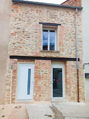 a brick building with two windows on it at Hygge en Méditerranée in Salses-le-Chateau