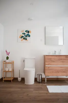 a bathroom with a toilet and a wooden dresser at Hygge en Méditerranée in Salses-le-Chateau
