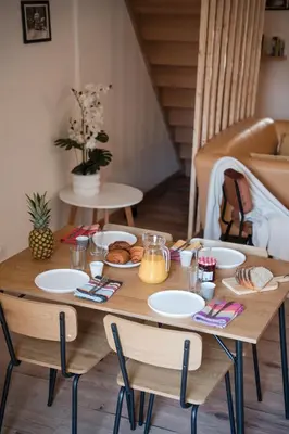 a wooden table with plates of food on it at Hygge en Méditerranée in Salses-le-Chateau