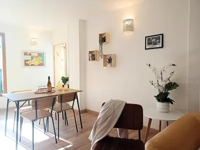 a dining room with a table and chairs at Hygge en Méditerranée in Salses-le-Chateau