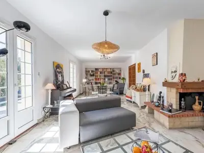 a living room with a couch and a fireplace at Maison des Artistes - Centre Ville in Narbonne