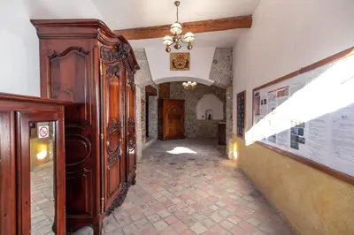 a hallway with a large wooden cabinet in a building at Chambre romantique du Couvent in Narbonne