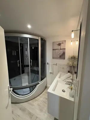 a bathroom with a large shower and a sink at Chambre romantique du Couvent in Narbonne