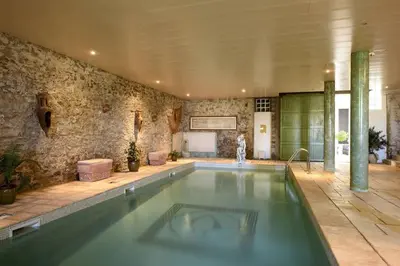 a swimming pool in a large room with at Appartement dans l'aile du château 130M2 6 personnes in Carcassonne