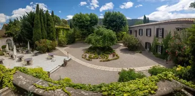 a garden with a fountain in the middle of a building at Appartement dans l'aile du château 130M2 6 personnes in Carcassonne