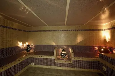 a bathroom with a bath tub with lights on the wall at Appartement dans l'aile du château 130M2 6 personnes in Carcassonne