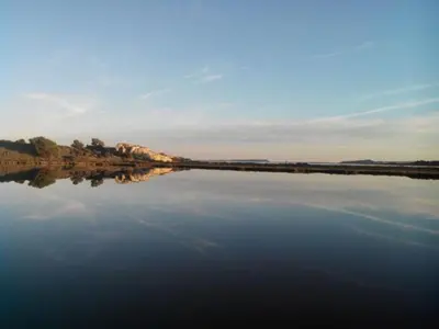 a large body of water with trees in the background at Le Doul Jolie villa au calme climatisée grande piscine jardin in Peyriac-de-Mer