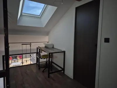 a small table in a room with a skylight at Apartement La Cuverie in Carcassonne