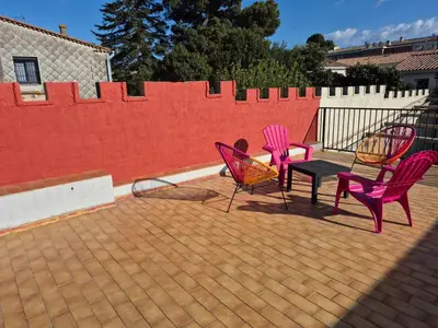 three chairs and a table on a patio at Apartement La Cuverie in Carcassonne