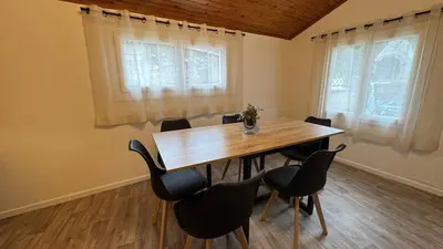 a dining room with a wooden table and chairs at My Agradi, Maison de village in Les Martys