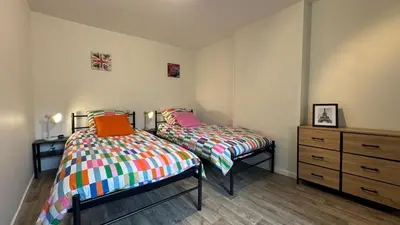a bedroom with two beds and a dresser in it at My Agradi, Maison de village in Les Martys
