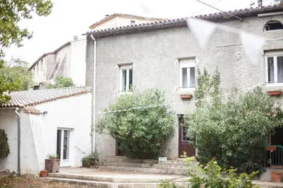 a white brick house with trees in front of it at Domaine Castelnaut gîte et château in Laroque-de-Fa
