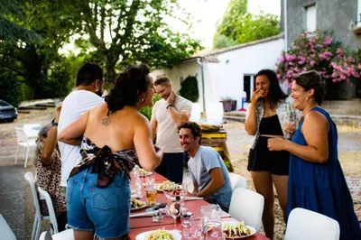 a group of people standing around a table at Domaine Castelnaut gîte et château in Laroque-de-Fa