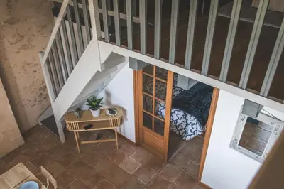 an overhead view of a room with a bed and stairs at L'intendance - calme et cosy, vieilles pierres in Saint-Félix-Lauragais