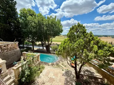 an image of a swimming pool in a garden at L'intendance - calme et cosy, vieilles pierres in Saint-Félix-Lauragais