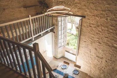 an overhead view of a staircase with a window at L'intendance - calme et cosy, vieilles pierres in Saint-Félix-Lauragais