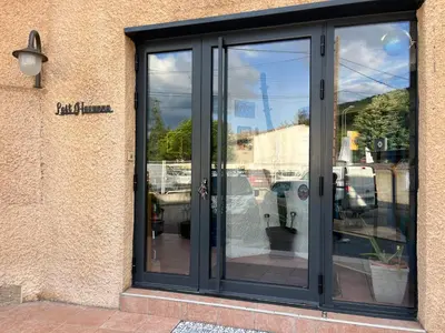 a glass door on the side of a building at Magnifique et grand loft classé 4 étoiles in Lavelanet