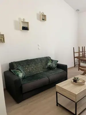 a living room with a couch and a coffee table at Appartement douzens in Douzens